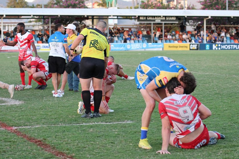 A Yeppoon Seagulls player consoles an Emu Park player after the extraordinary A grade grand final. Photo: Boothy's Action Photo Art