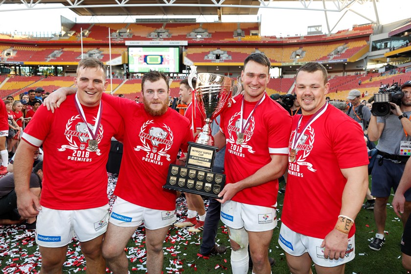 Nick Slyney celebrates winning the 2018 Intrust Super Cup premiership with his Redcliffe Dolphins team-mates Nathan Watts, James Taylor and Sam Anderson. Photo: QRL Media