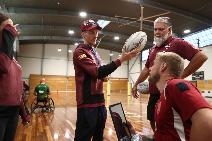 Queensland coach Jack Brown talks to a player at the team's Gold Coast camp. Photo: Jason O'Brien