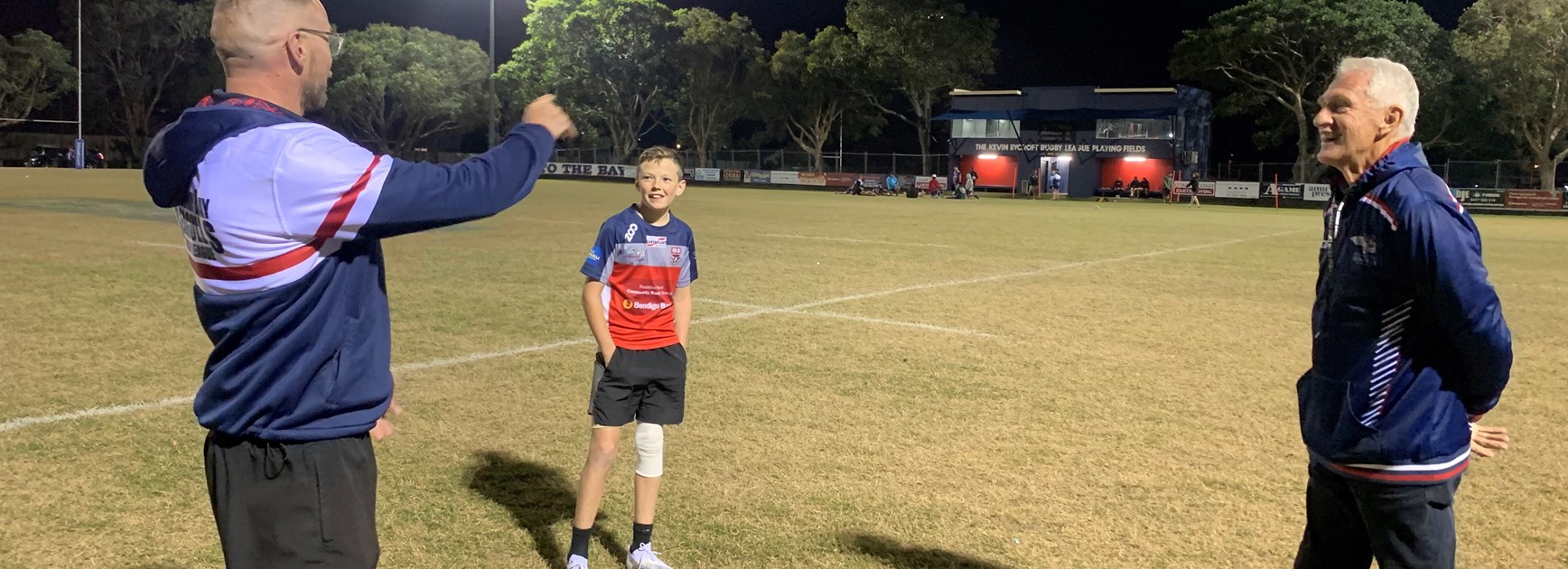 Darryl Fisher (left) and David Waite (right) giving some coaching tips to young Flynn.