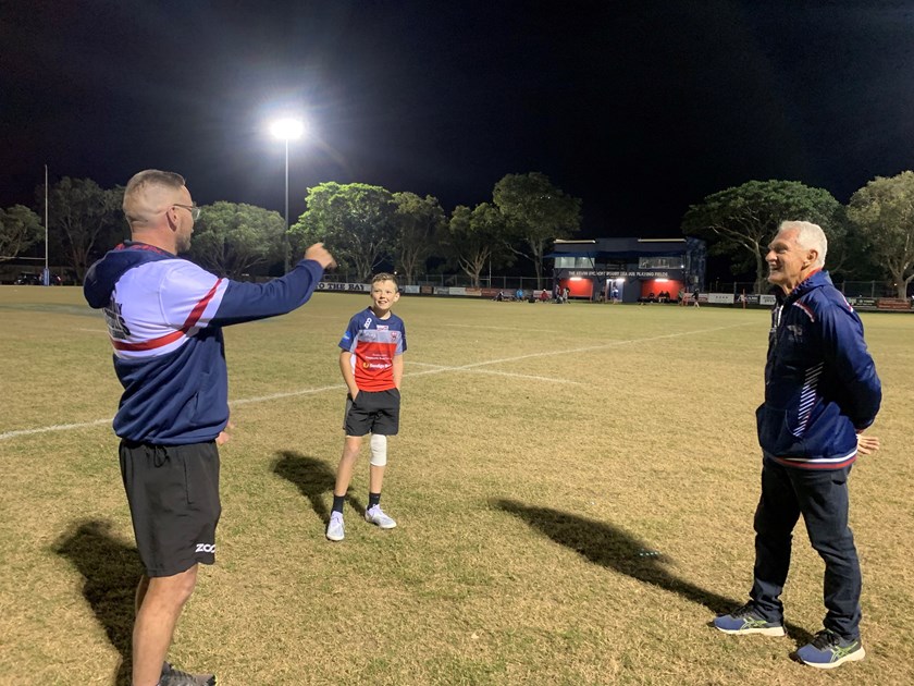 Darryl Fisher (left) and David Waite (right) giving some coaching tips to young Flynn.