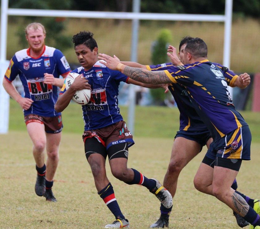 Roosters Under 18s player Kiefhar Rosas who stepped up to first grade tries to spin away from the grasp of two Edmonton Storm players Photo: Maria Girgenti
