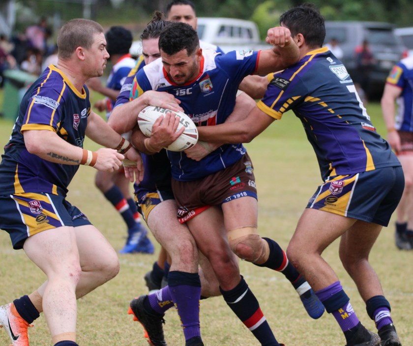 Atherton Roosters player Graham Clark Jnr comes up against three Edmonton Storm defenders Photo: Maria Girgenti