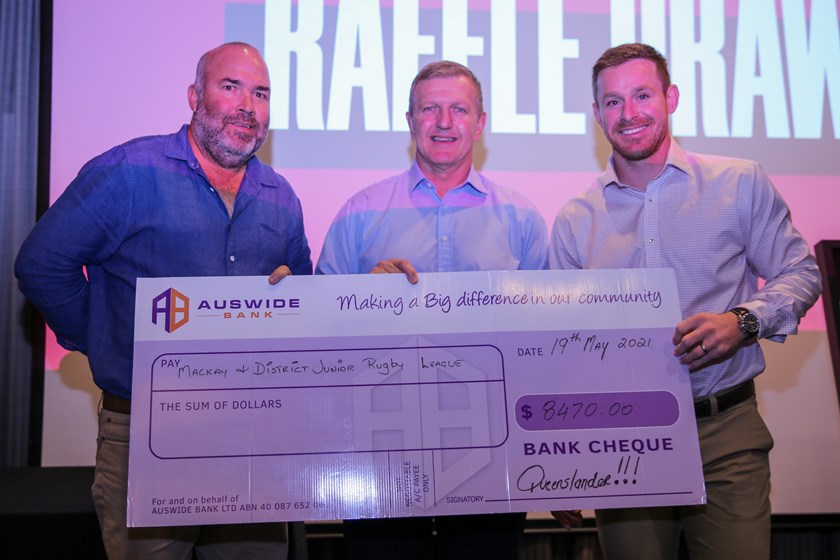 RLMD chair Heath Galletly accepting the cheque from Auswide Bank chief customer officer Damian Hearne and Queensland Maroons legend Michael Morgan. Photo: Cameron Stallard/QRL