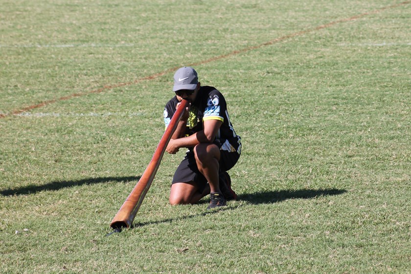 Ash Saltner playing the didgeridoo as part of Townsville's Norths Devils' National Reconciliation Week celebrations.