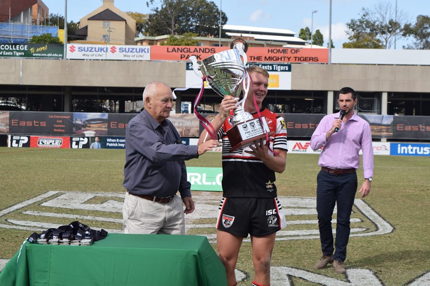 Phil Hall presents the Queensland state final winners Kirwan with the Phil Hall Cup. Photo: QRL Media