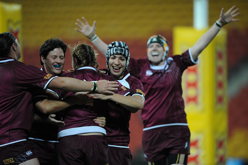 Johnson (centre, with the headgear) playing for Queensland in 2011.