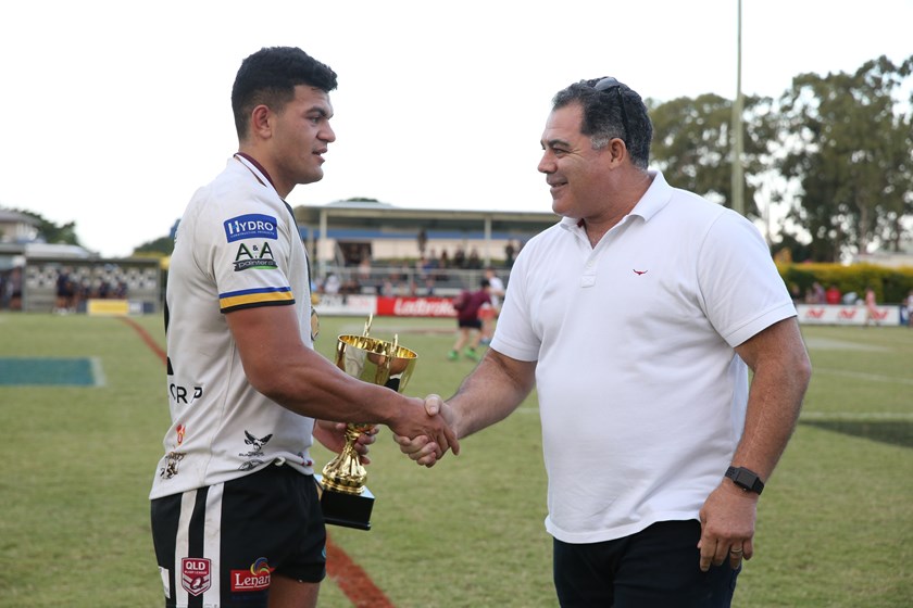 Mal Meninga presents Souths Logan captain David Fifita the Cup after the Magpies won the grand final.