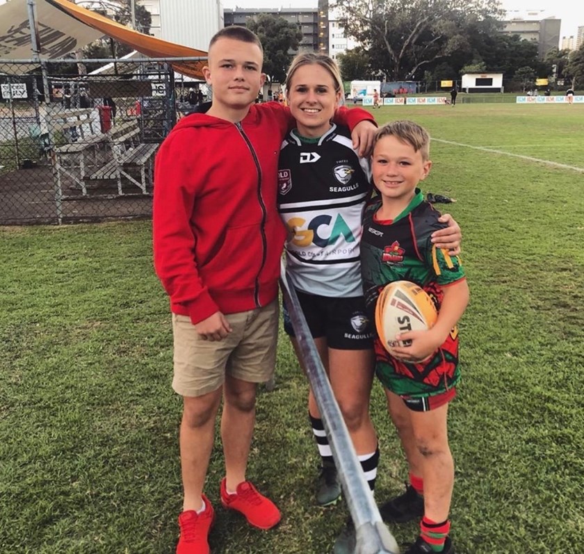 Brittany with her younger brothers who came to watch her play in her last game in her first season of footy.
