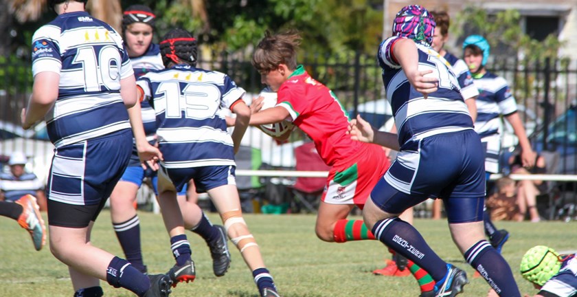 Hervey Bay’s player of the Under 13 grand final Preston King heads for his second try against Brothers.