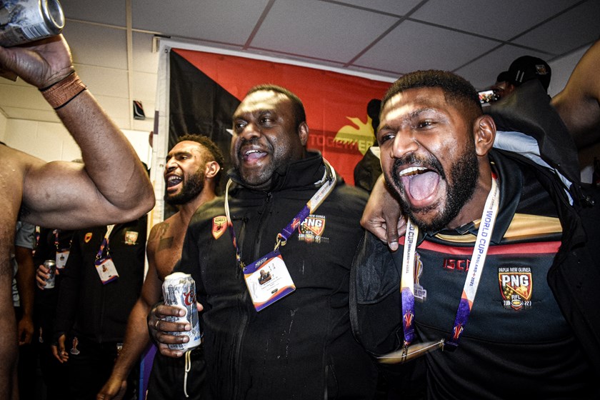 Tanabi celebrates with teammates after PNG's victory over Cook Islands. 