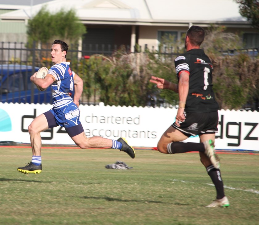 Rookie winger Mitchell Clayton is chased by Easts Magpies’ Clinton Horne on his way to a stunning 95 metre try which set Past Brothers on track to victory in the Bundaberg Broadcasters A Grade Premiership grand final. Photo: Vince Habermann