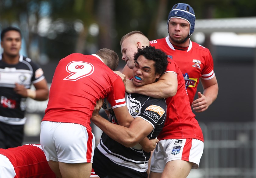 Xavier Coates is tackled by Illawarra defenders. Photo: QRL Media / Jason O'Brien
