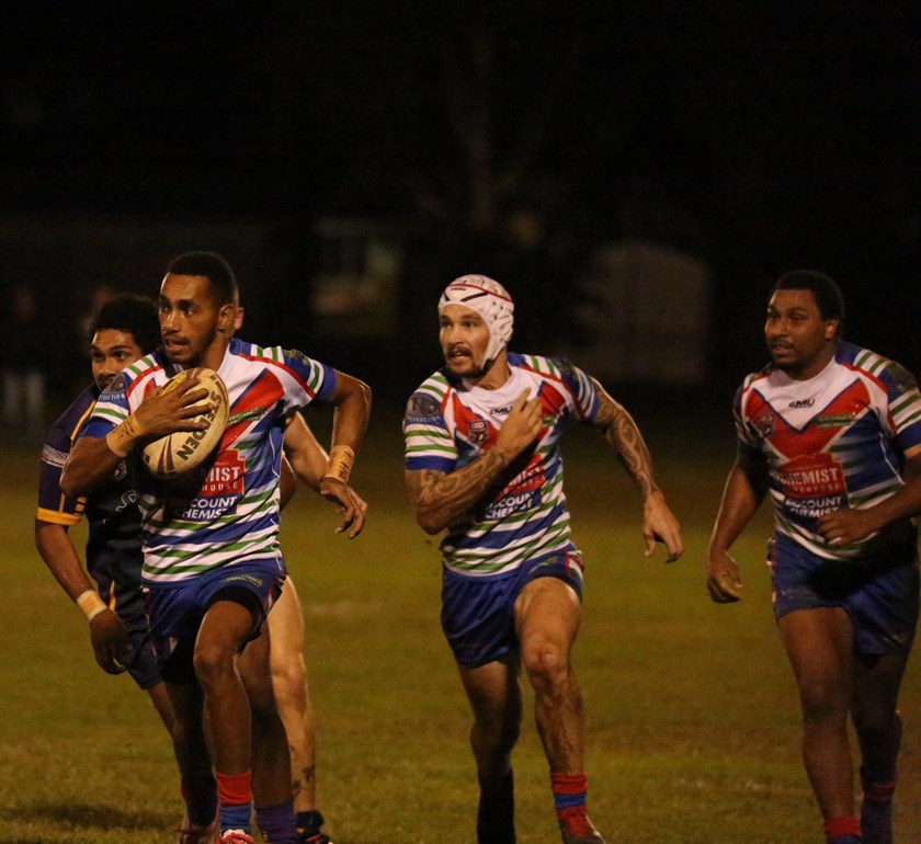 Jackson Laza runs with the ball well supported by Innisfail team mates Aaron Jolley and Elia Mooka Photo: Maria Girgenti