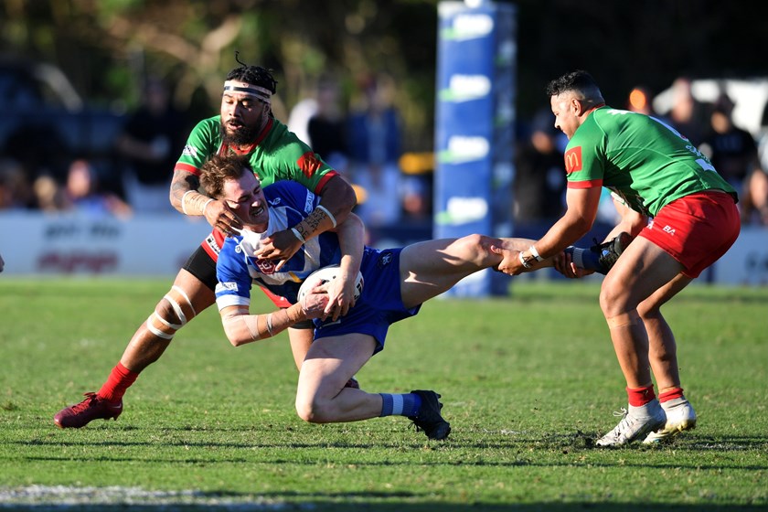 Bulimba grand final try scorer Lachlan Pope is tackled. Photo: Vanessa Hafner