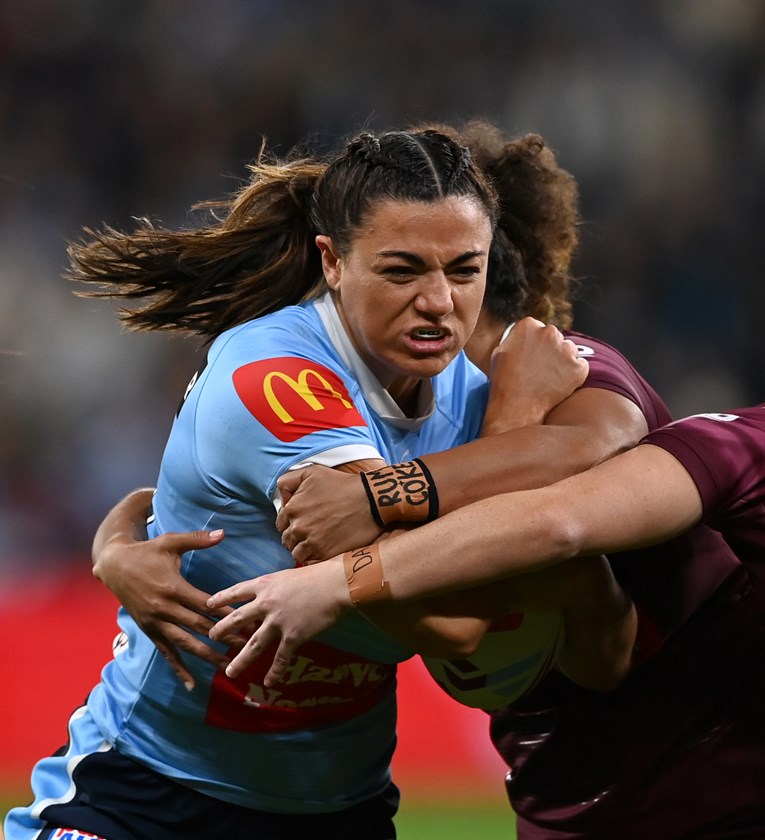 Shaniah Power makes a tackle on Millie Boyle in Game I of State of Origin, with her "Rum + Coke" wrist tape visible. Photo: NRL Imagery