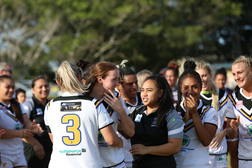 Player of the Holcim Cup winner Tamika Upton is congratulated by her team mates. Photo: Jorja Brinums / QRL
