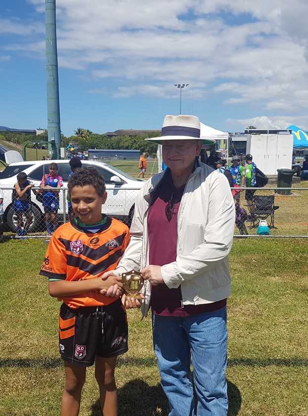 Nicholas Muriata from Tully Tigers who was the winner of the Catch The High Ball competition was presented with the Francis Mosby Memorial trophy by Honourable Warren Pitt AM.