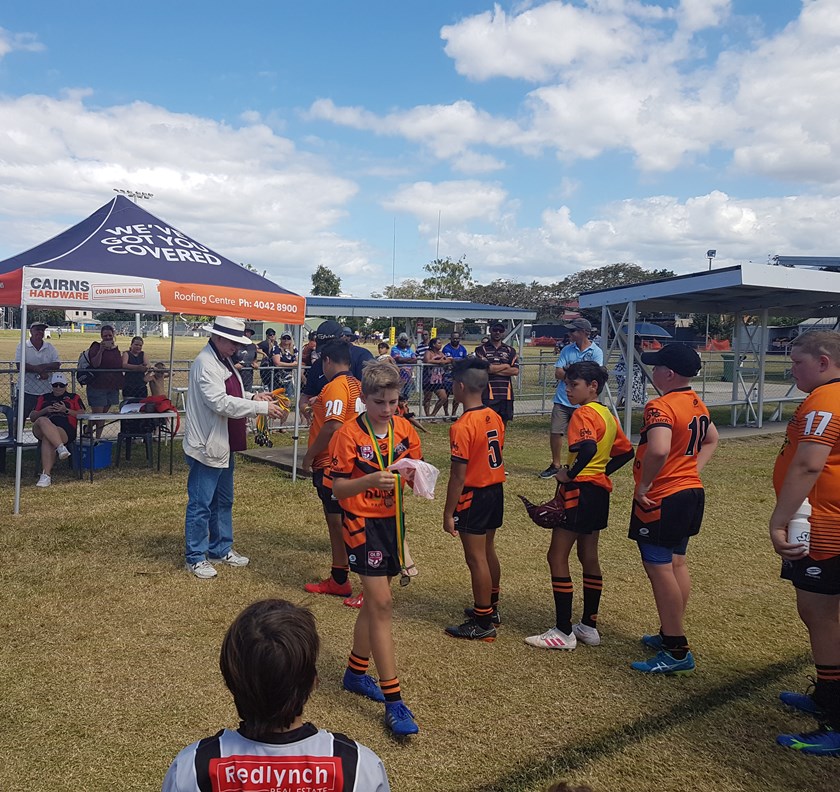Honourable Warren Pitt AM presented the runner up medals to players from the Tully Tigers team.
