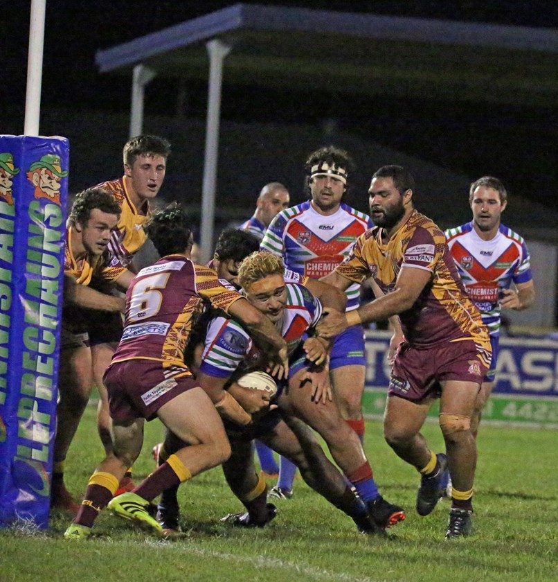 Despite being swarmed on by Suburbs players Innisfail's Usaia Fonongaloa surged dangerously close to the try line. Photo: Maria Girgenti