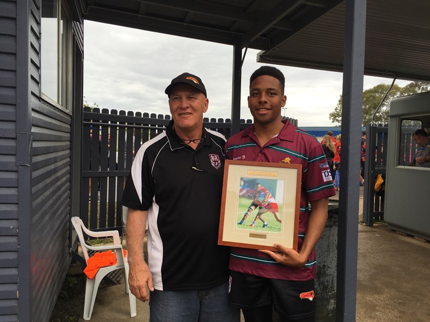 Shane McNally presents the 2016 Greater Brisbane Junior Rugby League under 14 representative player of the year award to Keegan Vandenberg.