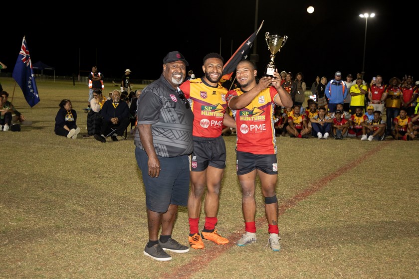 QRL Indigenous Advisory Committee member Eddie Monaei hands over the trophy to representative of the winning PNG men's team. Photo: Jim O'Reilly/QPICC