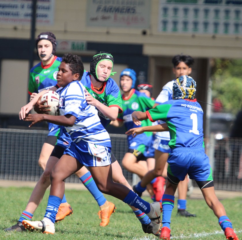 A Cairns Brothers player makes a strong run in the Under 13s game against Innisfail Brothers. Photo: Maria Girgenti