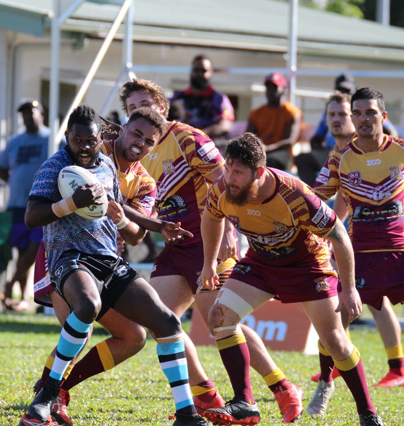 Mossman's Judah Toby avoids the clutches of Southern Suburbs players Photo: Maria Girgenti