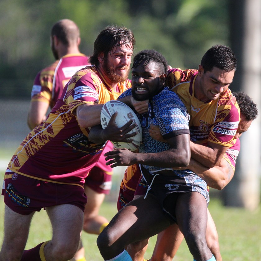 Aggie Gibuma, Mossman's youngest player is stopped in his tracks by two Southern Suburbs players Photo: Maria Girgenti