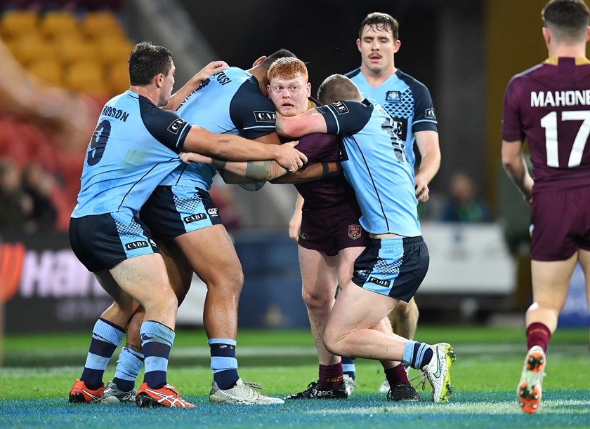 Corey Horsburgh is surrounded by NSW defenders in an Under 20 representative match against NSW.