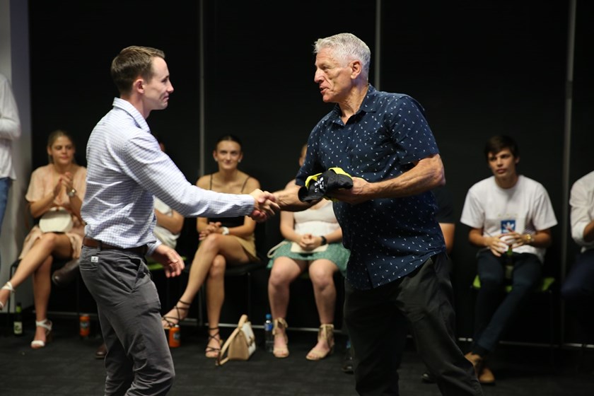 Jack Ebert is congratulated on his Intrust Super Cup debut by Eddie Ward. 