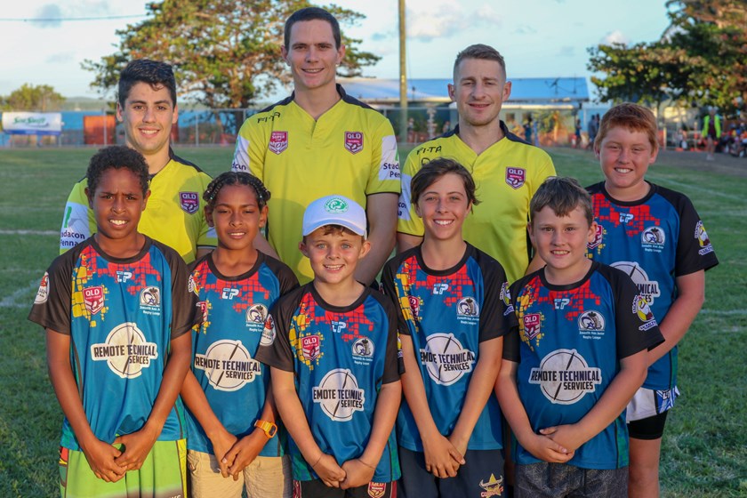 Wyatt Raymond with Giulian Fichera and Nathan Cornick and some junior players at Thursday Island during 'Get in the Game' Country Week in 2019. Photo: QRL