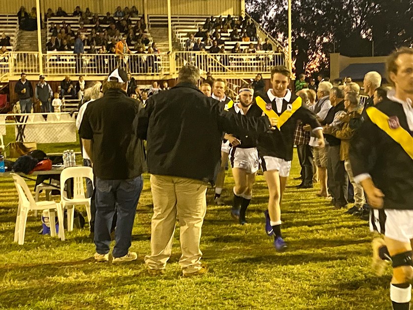 The Blackall Magpies run onto the field in their replica jerseys. Photo: Peter Rafter