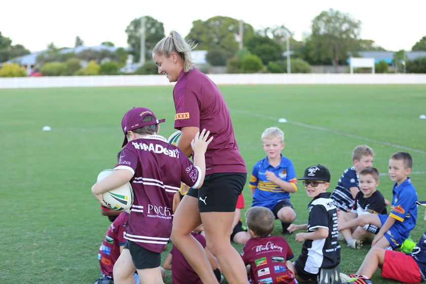 Daly Olsen reaching out to Meg Ward during a game. Photo: Jennifer Bertolissio/QRL