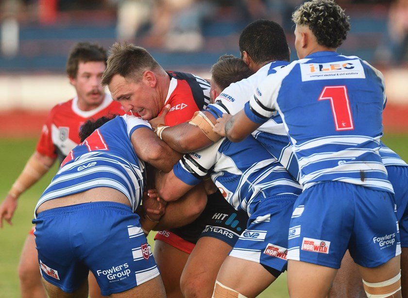 Scott Bolton is wrapped up by the Brothers defence. Photos: Darryl Day