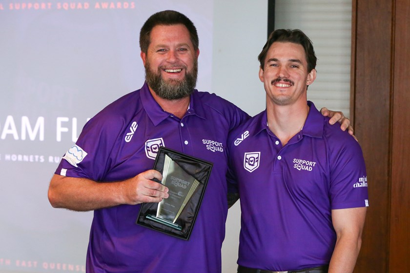 Adam Flier receives his award from QRL South East wellbeing operations manager Dave Sheridan. Photo: Jacob Grams/QRL