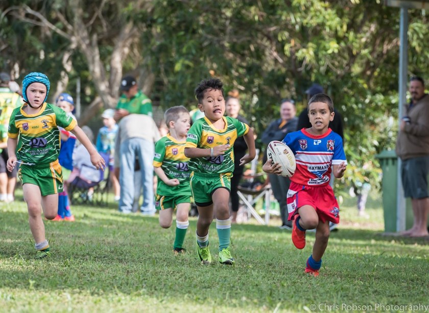 An Ivanhoe junior rugby league player runs with the ball in a game against Mareeba. Photo: Chris Robson