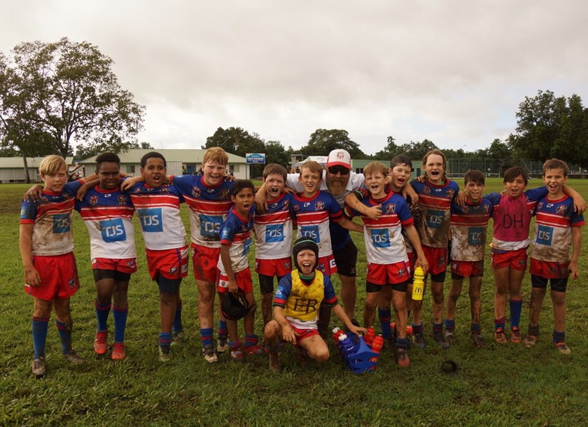 Ivanhoes junior rugby league players and their coach after a muddy game of football