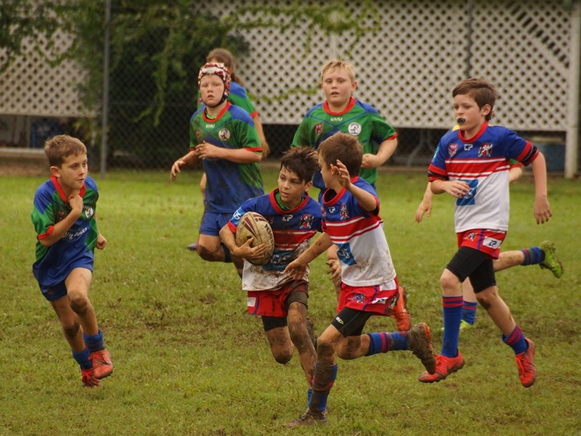 Ivanhoes Knights junior players in action on a muddy field