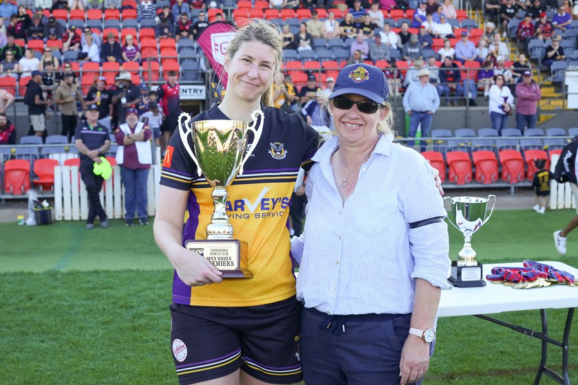 Dore accepts the trophy after the grand final.