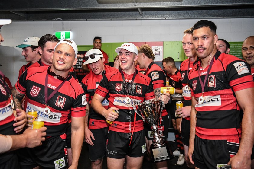 Westcott, with the trophy, celebrates with West Brisbane teammates. Photo: Vanessa Hafner/QRL