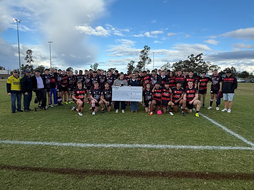 The Dalby Devils present the $10,000 donation to the McGrath Foundation. 